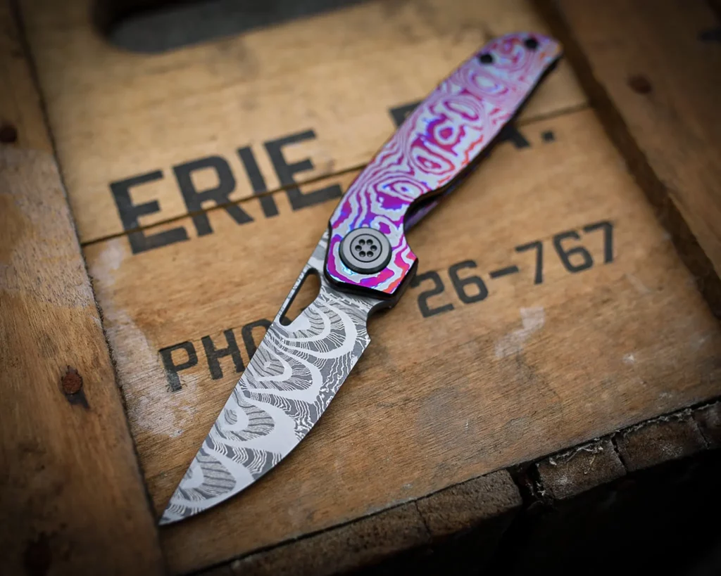 Collaboration with Carver knife Co - Norris Fireclone 2 stainless damascus blade, Zircuti Show and Lock sides, Zirconium pivot screws, collars, clip (with green tritium inlay) and backspacer.