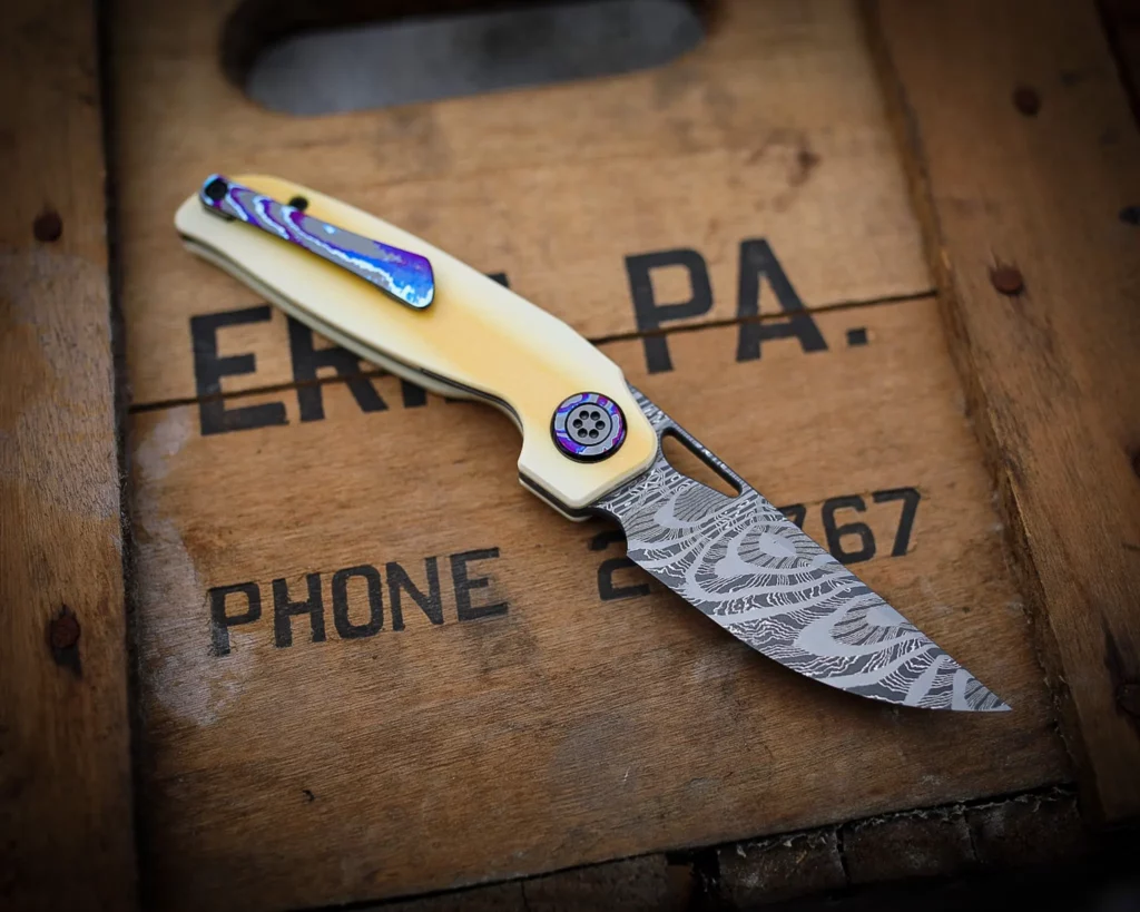Collaboration with Carver Knife Co - Norris Fireclone 2 stainless damascus blade - Westy AIM scales - Dark Ti pivot collars, clip and back spacer - zirc pivot screws. (Back Side)